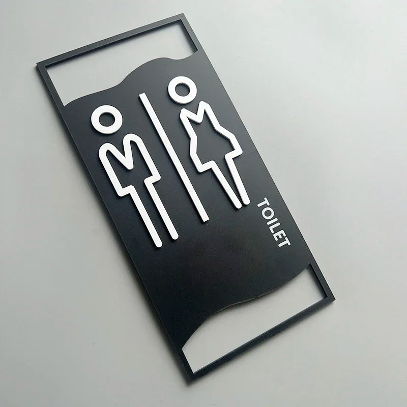 signalisation toilettes moderne symboles homme femme texte TOILET bois brun clair blanc tringle noire