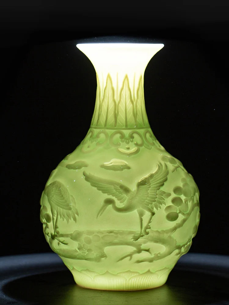 Vase décoratif en verre translucide de couleur jaune pâle avec un motif en relief représentant des oiseaux et des fleurs.