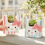 cache pot résine forme chat blanc bleu rose yeux noirs narines roses sourcils noirs