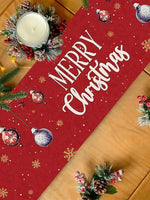 Décoration de Noël avec un grand texte rouge et blanc "Merry Christmas" sur un fond à motifs de flocons de neige, accompagné de branches de sapin et de pommes de pin.