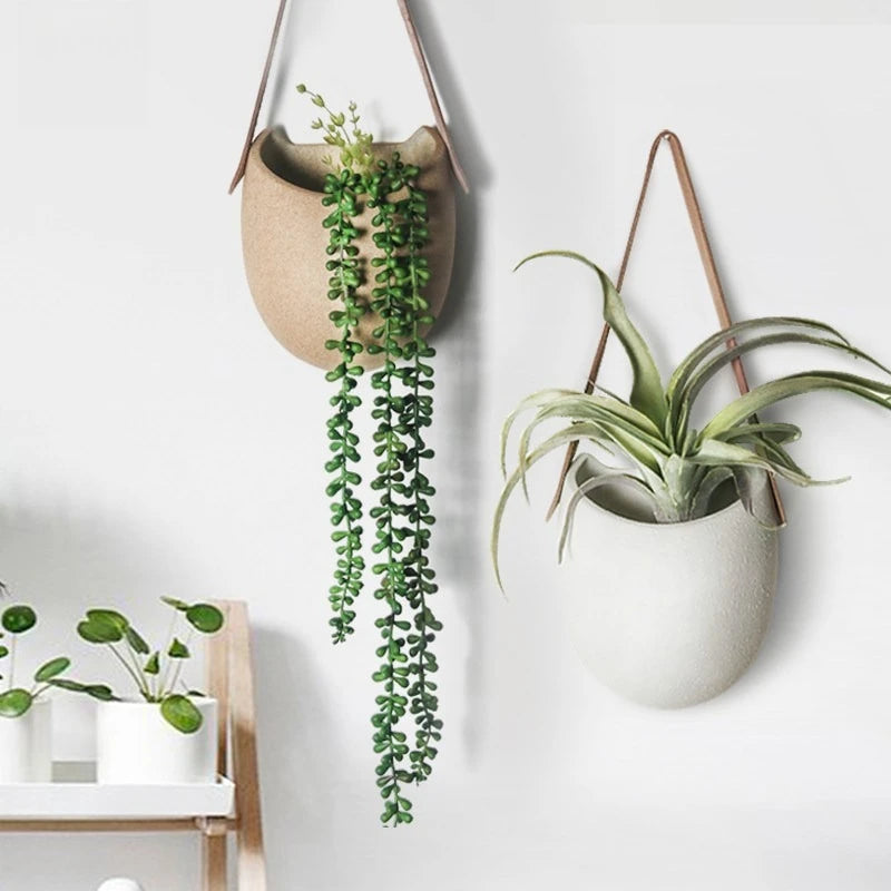 cache pot suspendu céramique blanc texture granulée minimaliste tringle cuirintérieur décoration plante fleurmodernestyle rusticitéélégant