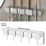 organisateur mural gris outils nettoyage crochets serpillères balais minimaliste autoadhésif