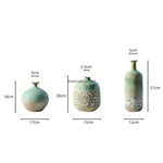 vase céramique rustique vert beige marron texturé variations couleur branches feuilles arrangement floral