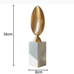 sculpture abstraite moderne minimaliste blanc doré beige gris foncé socle pierre marbre