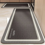 Tapis d'entrée rectangulaire de couleur grise avec bordures blanches, idéal pour accueillir les visiteurs dans un hall.