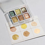 peintures aquarelle palette compacte bleu vert violet rose beige jaune blanc texture granuleuse opaques