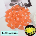 pierres fluorescentes bleu vert jaune rose modernes lisses jardin patio décor lumineux