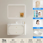 meuble salle bain noir blanc tiroirs vasque ornements dorés classique fixations murales accessoires cosmétiques
