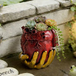 pot fleurs cœur anatomique rouge mains dorées plantes succulentes décoratives escargot poisson love speech