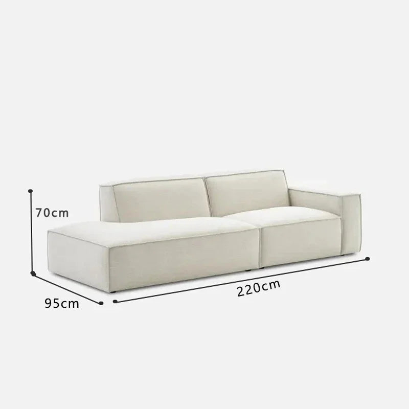 canapé d'angle moderne beige clair uni confortable salon minimaliste inclusion coussins tapis