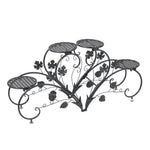 meuble plante métal noir niveaux feuilles stylisées art nouveau pots blancs arrosoir bleu balcon