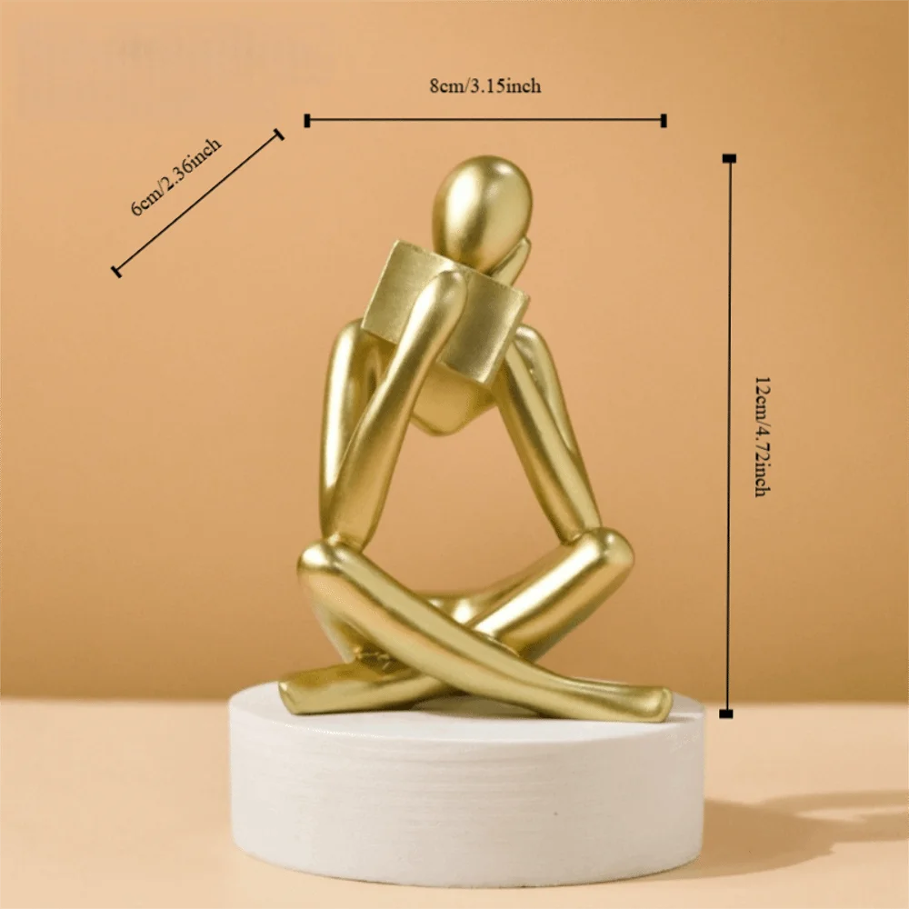 figurine deco moderne or noir blanc personne assise livre socle chambre abstraction minimalisme