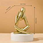 figurine deco moderne or noir blanc personne assise livre socle chambre abstraction minimalisme