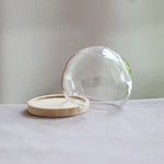 vase boule verre transparent base bois couvercle fleurs séchées