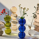 vase moderne transparent sphères empilées jaune clair rose bleu vert brun