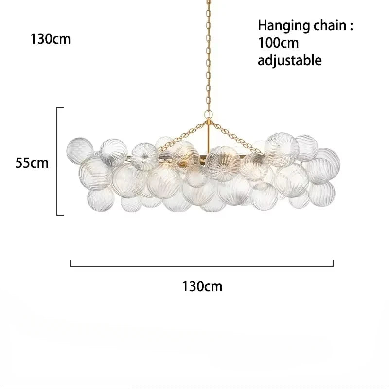 suspension lumineuse moderne verre transparent chaîne dorée led acier poli contemporain lumière chaude chambre