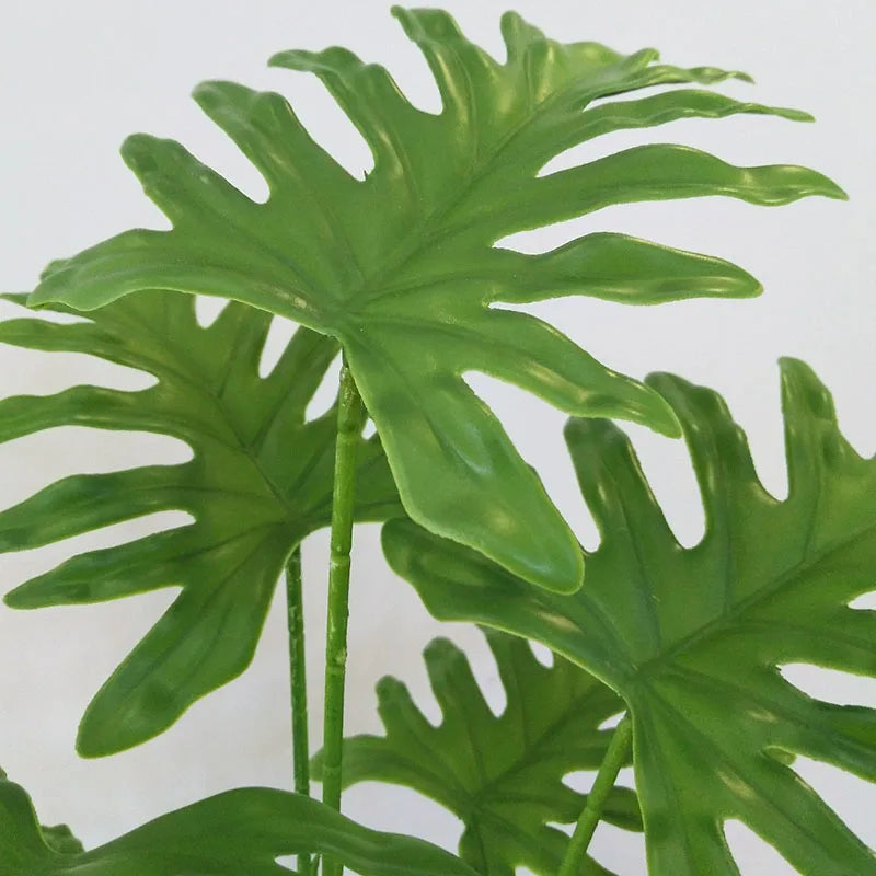 plantes artificielles vertes feuilles larges moderne decoration intérieure feuilles nervures perforations racines apparentes minimaliste