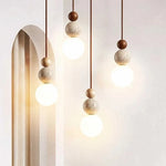 lampe suspendue pierre moderne ampoule g9 blanc beige marron foncé texture granulée lumière opaques