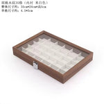 boîte bijoux contemporaine transparente compartiments blancs texture bois poignée métallique minimaliste organisation trousse toilette