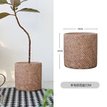 Pot plante tissé marron clair moderne rustique plante verte graines noires serviette blanche