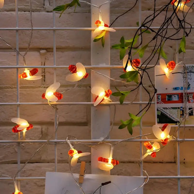 Guirlande lumineuse LED abeille créative allumée en blanc chaud dans une chambre