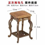 table basse bois rose classique gravures artisanal marron clair pot plante figurine cadre photo