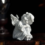 statue ange enfant triste sculpture résine détaillée plumes livres dorés fleurs bleues vintage
