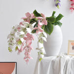 branche artificielle fleurs naturelles extérieur accrochées blanc vert feuilles larges minimaliste