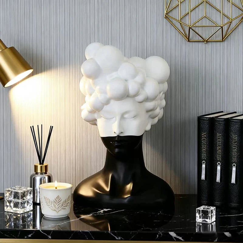 statue tête noire blanche texture mat moderne abstraite bougie concombre loupe livres lampe