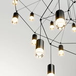 suspension lumineuse moderne fer noir structure géométrique interrupteur bouton éclairage intérieur minimaliste