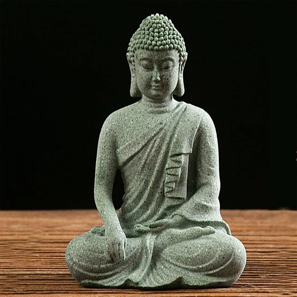 statuette bouddha assise gris vert texture pierre zen minimaliste abstraite galets mousse plateau noirscriçãopta
