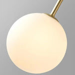 suspension lumineuse moderne sphères translucides structure métallique or rouge brun lumière led chambre salon