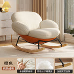 fauteuil bascule moderne beige noir orange roulettes coussin repos minimaliste salon