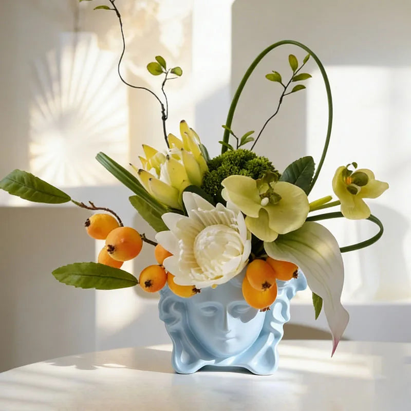 vase résine bleu clair fleurs artificielles orchidée lotus roses feuillage classique décoration intérieure tête