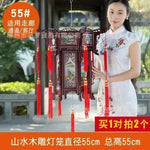 lanterne traditionnelle chinoise bois sculpté rouge décorative pompon fête mariage jardin