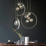 lumière suspendue moderne pendentif géométrique transparent cercles métalliques dorés chambre salon