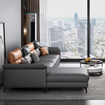 Canapé d'angle moderne cuir gris chaise lounge pieds noirs coussins géométriques salon bois composite