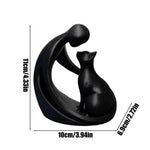 statuette moderne personne chat blanc noir stylisée abstraiteDecoration intérieure livre plante verte bougie chandelle