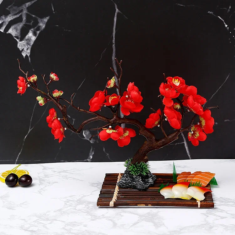 composition florale artificielle fleurs cerisier rouge rose vert branches noires pierre décorative moderne intérieur