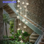 suspension lumineuse moderne transparente dorée facettes géométriques élégantes multiples lampes