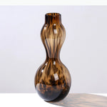vases modernes translucides opaques motifs tourbillonnaires branches fleurs artificielles marron orange beige