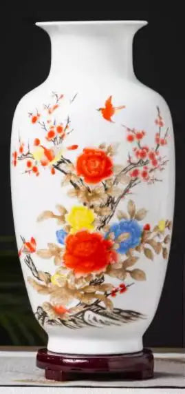Vase céramique blanc décoré de fleurs rouges et jaunes, avec un pied en bois.