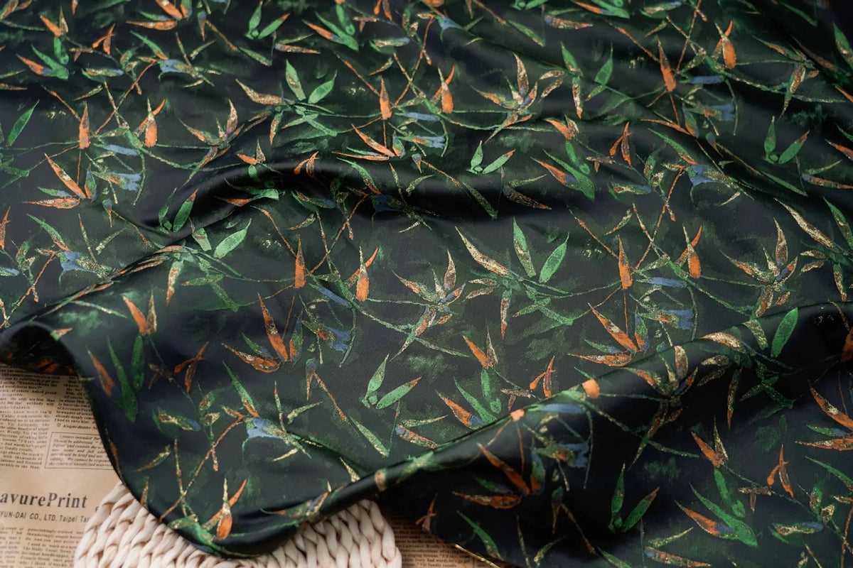 tissu imprimé feuilles bambou noir vert orange respectueux environnement largeur 165cm opacité decoration interieur