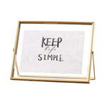 cadre photo moderne minimaliste or noir pieds triangulaires texte simple verre