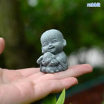statue moine animal résine gris texture granuleuse artisanale jardin zen sereine souriante decoration extérieure