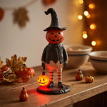 figurine halloween citrouille lumineuse orange visage chapeau robe noire bas rayés automne