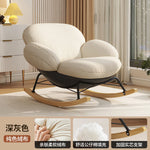 fauteuil bascule moderne beige noir orange roulettes coussin repos minimaliste salon