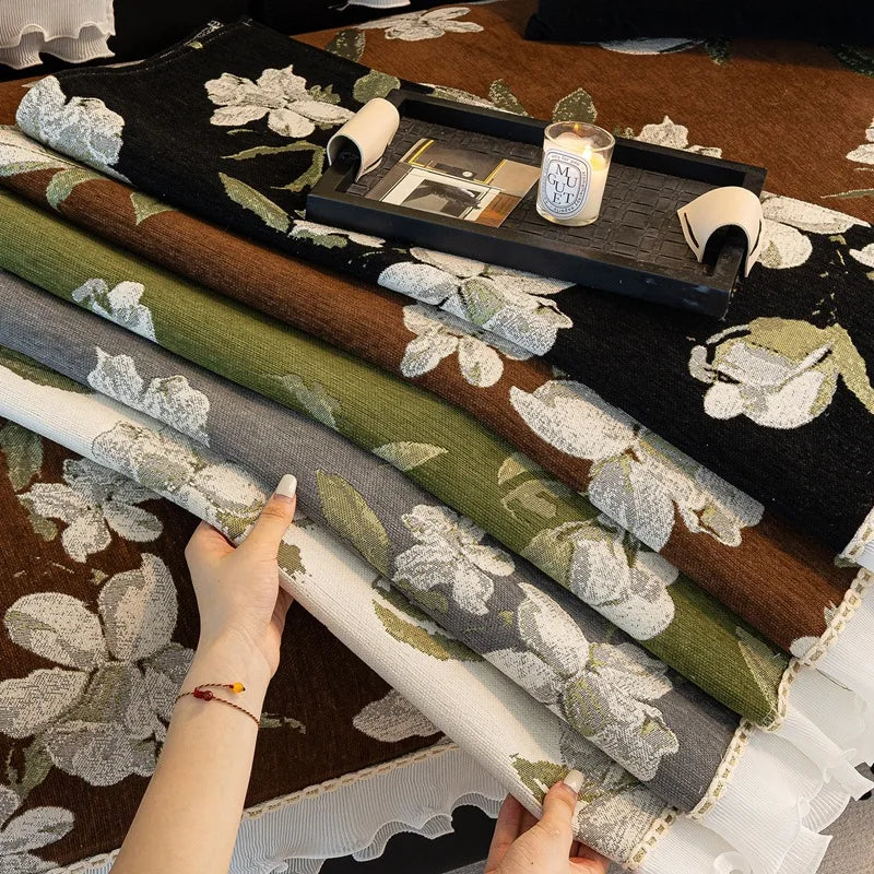 Une image d'un espace de travail créatif avec des matériaux textiles floraux et un ordinateur portable sur un plateau en bois.