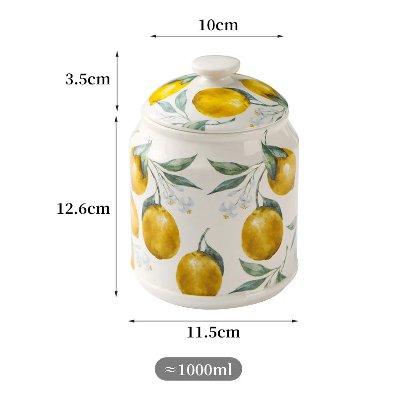 Pot en céramique blanc avec motif de citrons jaunes et de feuilles vertes.