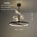 suspension lumineuse moderne sphères verre transparent anneaux métalliques noir doré grisclair